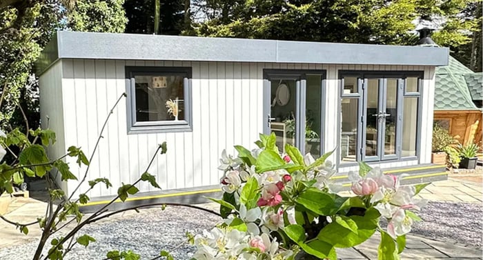 Modern granny annexe surrounded by lush garden.