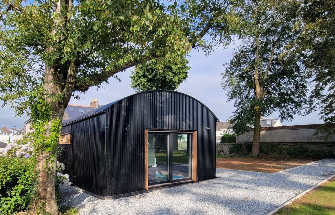 Compact modern granny annexe nestled in lush garden setting.