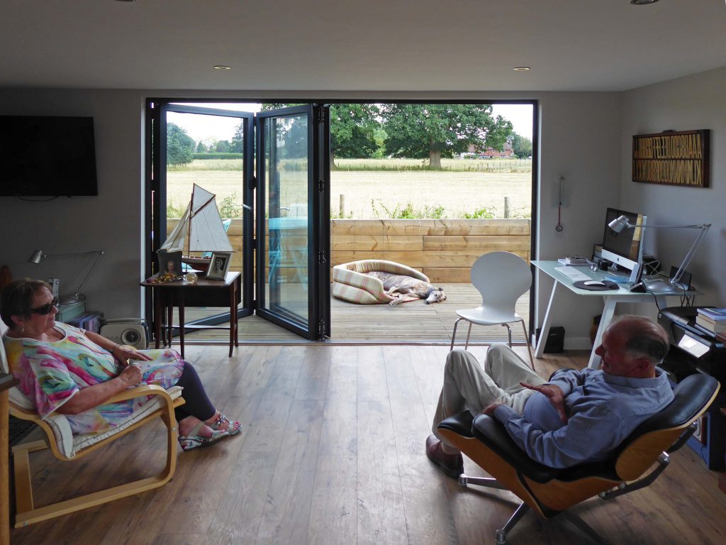 Elderly couple relaxes in their spacious, modern granny annexe.