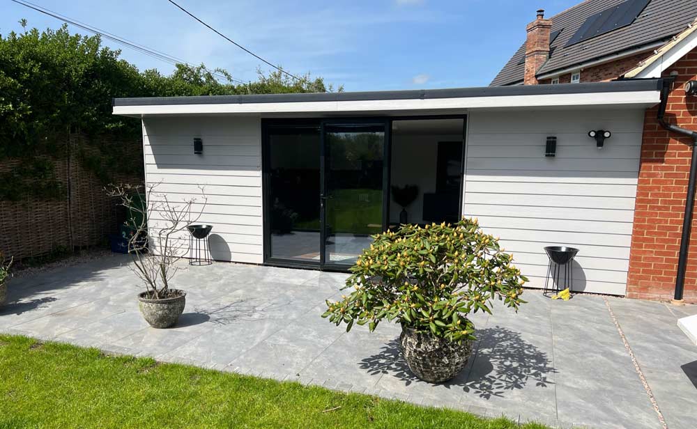 Modern granny annexe in garden, ideal for extended family living.
