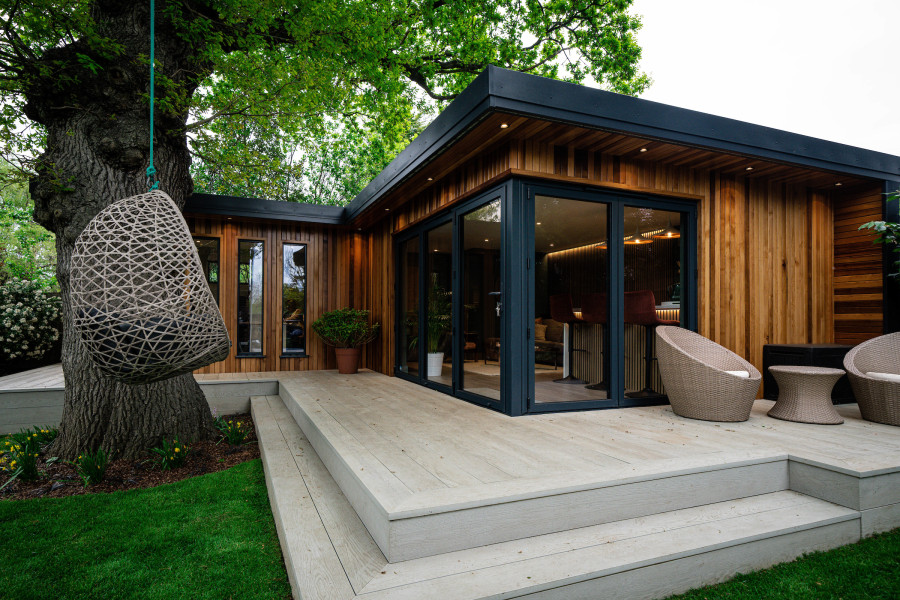 Modern granny annexe integrated elegantly with natural garden surroundings.