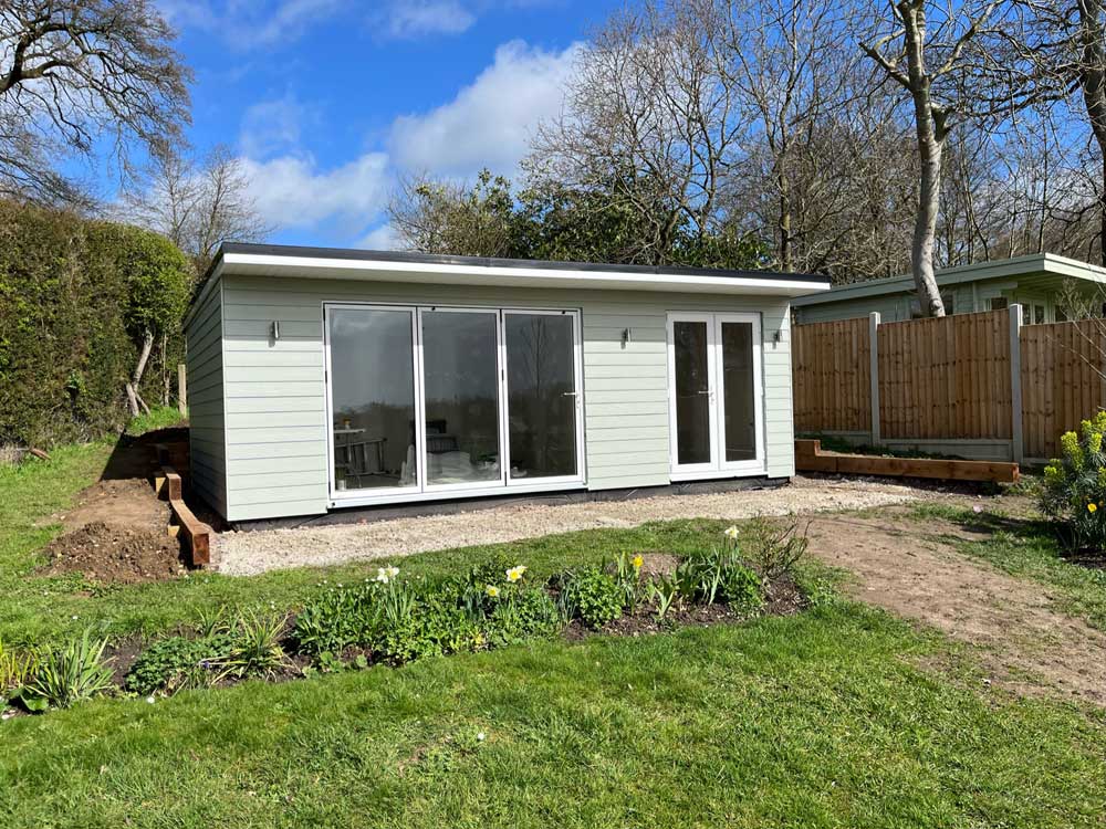 Modern granny annexe set in a lush garden setting.