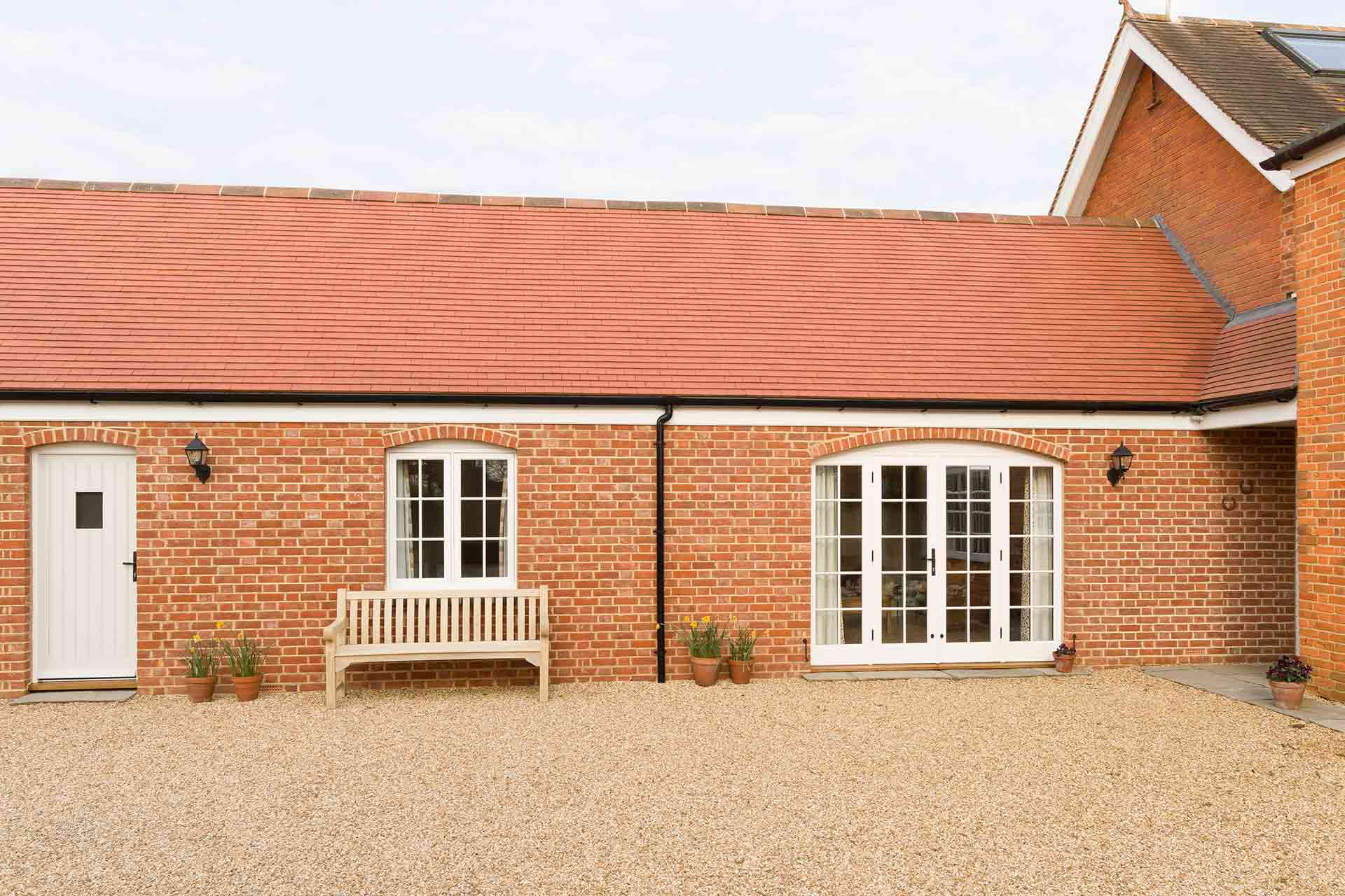 Modern granny annexe with brick facade and cozy interior space.