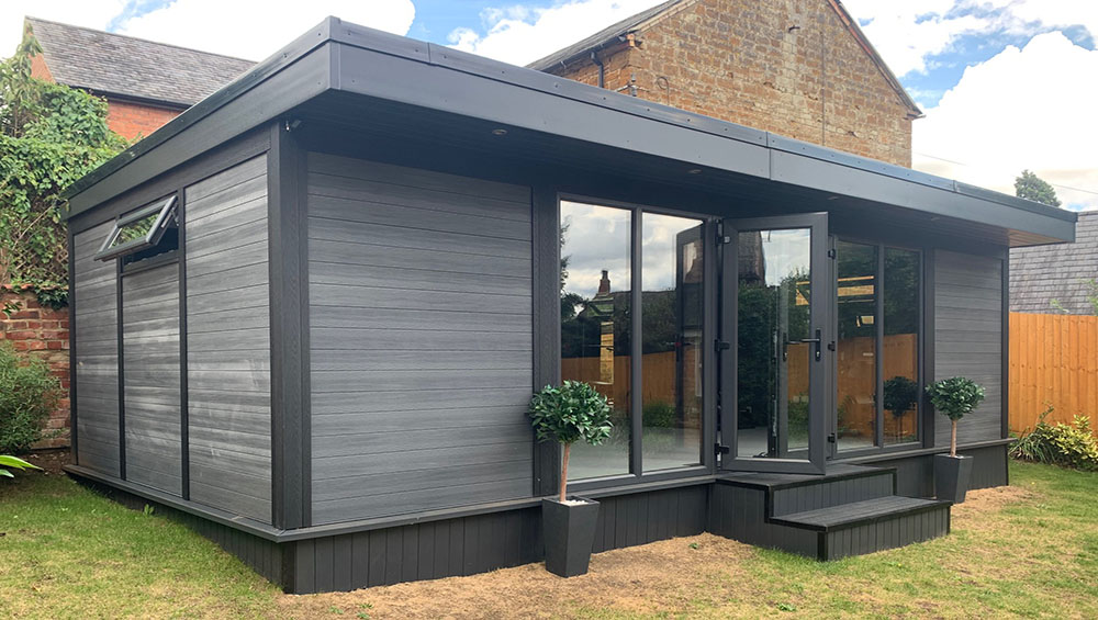 Modern granny annexe with large windows and sleek design.